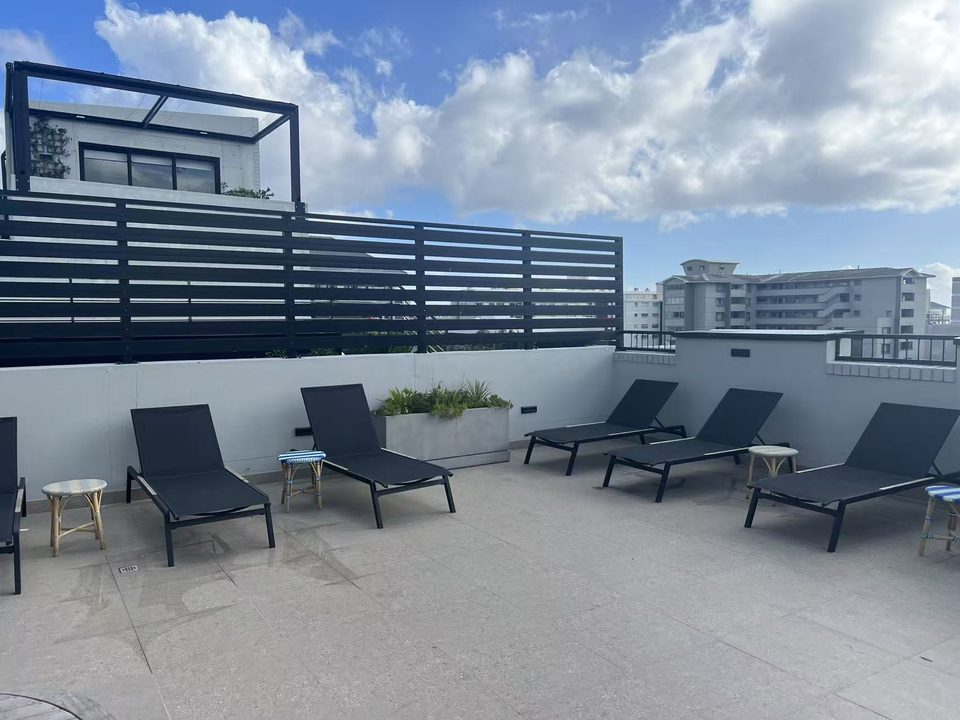 Rooftop deck chairs with Sea Point behind