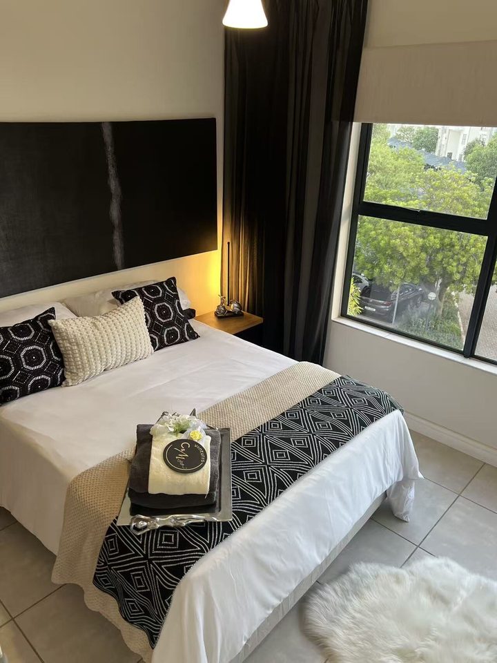 Bedroom with a double bed and a garden window